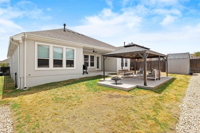 124 Adina Dr, Dripping Springs, TX 78620 - rear view of property with a gazebo, a patio area, a ceiling fan, an outdoor living space with a fire pit, and stucco siding