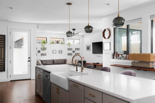 4420 Mount Vernon Dr Unit A, Austin, TX 78745 - kitchen featuring stainless steel dishwasher, a sink, open floor plan, dark wood-type flooring, and hanging light fixtures