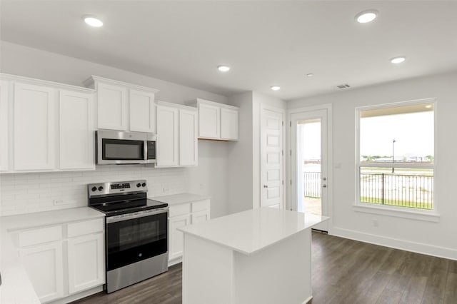 2035 Cora Ivy Loop, Round Rock, TX 78665 - kitchen with appliances with stainless steel finishes, backsplash, white cabinetry, dark wood-style floors, and recessed lighting