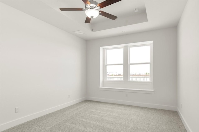 2035 Cora Ivy Loop, Round Rock, TX 78665 - unfurnished room featuring light carpet, baseboards, a tray ceiling, and a ceiling fan