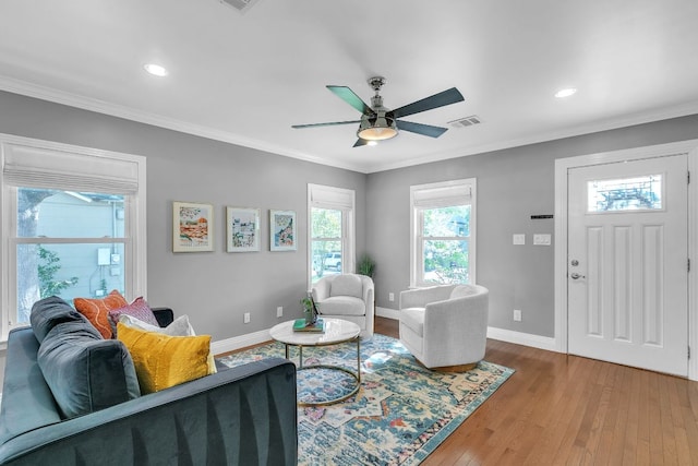 1308 Kinney Ave, Austin, TX 78704 - living room featuring wood finished floors, baseboards, ceiling fan, crown molding, and recessed lighting