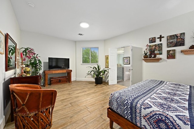 bedroom with light wood-style floors and baseboards