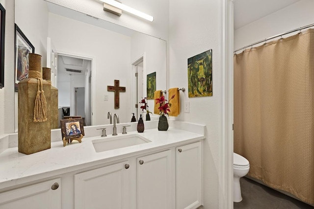 bathroom featuring toilet, vanity, and tile patterned floors