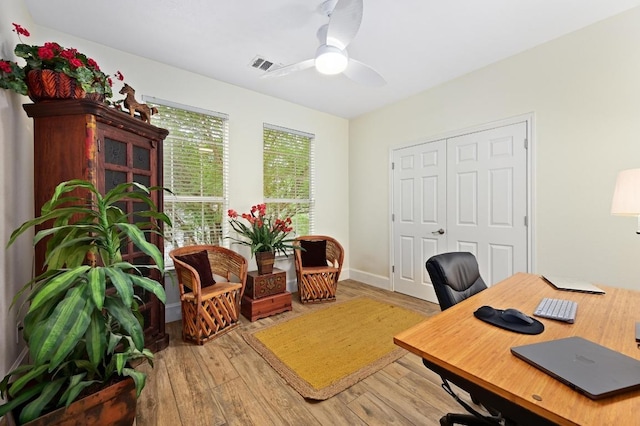 office space with a ceiling fan and light wood-style flooring