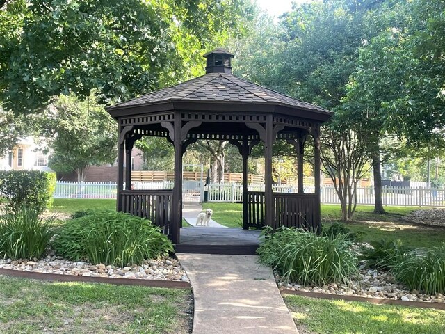 view of home's community with fence and a gazebo