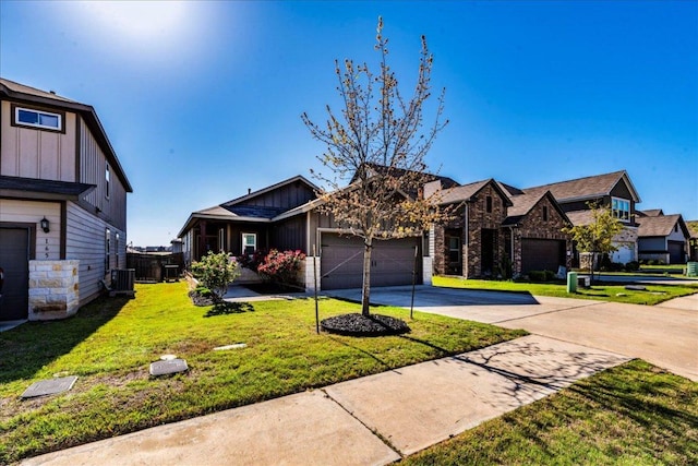 view of front of home with driveway, an attached garage, board and batten siding, central AC unit, and a residential view
