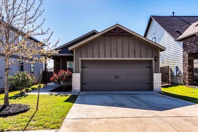 view of front of home featuring board and batten siding, concrete driveway, a garage, a front lawn, and stone siding