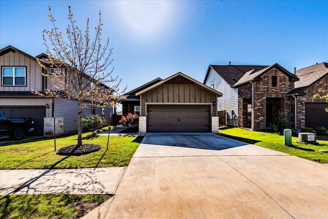 view of front of house with board and batten siding, a front lawn, driveway, and an attached garage