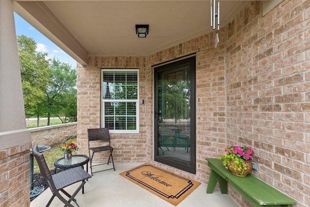 308 Hobby St, Georgetown, TX 78633 - doorway to property featuring brick siding and covered porch