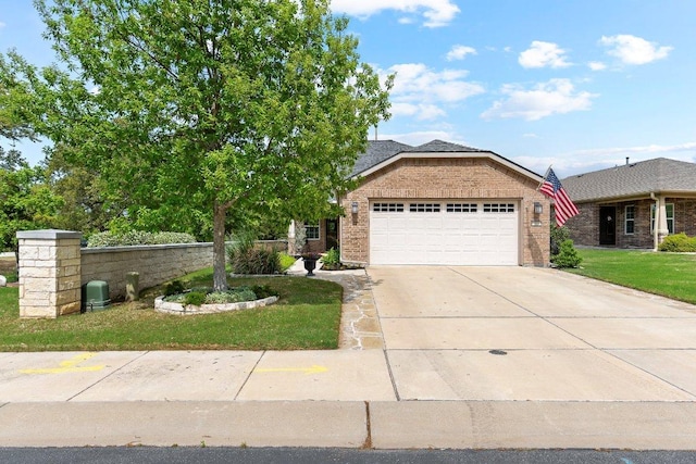 308 Hobby St, Georgetown, TX 78633 - view of front of property featuring brick siding, an attached garage, driveway, and a front lawn