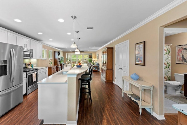308 Hobby St, Georgetown, TX 78633 - kitchen featuring appliances with stainless steel finishes, a sink, recessed lighting, crown molding, and dark wood finished floors