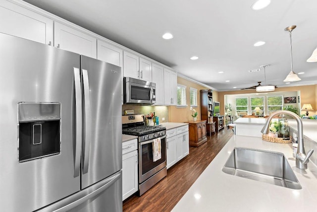 308 Hobby St, Georgetown, TX 78633 - kitchen featuring appliances with stainless steel finishes, a sink, dark wood-style flooring, recessed lighting, and light countertops