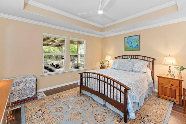 308 Hobby St, Georgetown, TX 78633 - bedroom with wood finished floors, a raised ceiling, baseboards, and ornamental molding