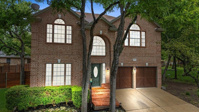6301 Harrogate Dr, Austin, TX 78759 - view of front of home with concrete driveway, brick siding, and a garage