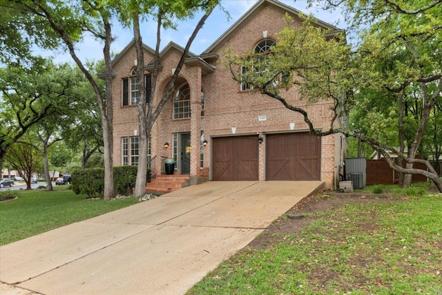 6301 Harrogate Dr, Austin, TX 78759 - view of front of home with brick siding, driveway, a garage, and a front yard