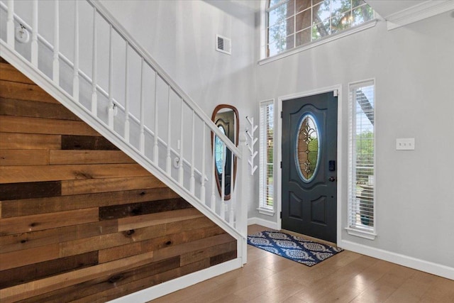 6301 Harrogate Dr, Austin, TX 78759 - foyer entrance featuring stairway, wood finished floors, baseboards, and a high ceiling