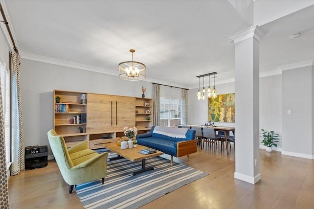 6301 Harrogate Dr, Austin, TX 78759 - living room with a chandelier, crown molding, wood finished floors, decorative columns, and baseboards