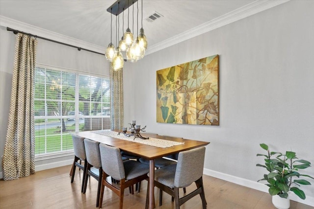 6301 Harrogate Dr, Austin, TX 78759 - dining area featuring baseboards, healthy amount of natural light, a chandelier, crown molding, and wood finished floors