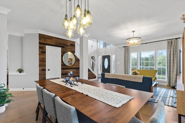 6301 Harrogate Dr, Austin, TX 78759 - dining area with a chandelier, wood walls, crown molding, stairs, and baseboards