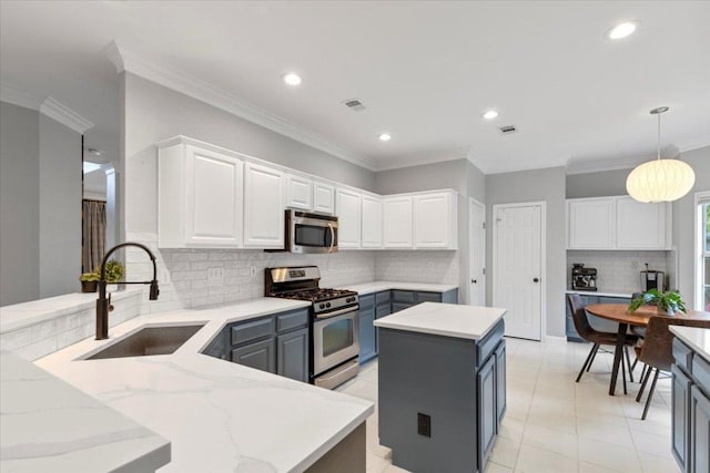 6301 Harrogate Dr, Austin, TX 78759 - kitchen with appliances with stainless steel finishes, a sink, white cabinetry, decorative backsplash, and recessed lighting