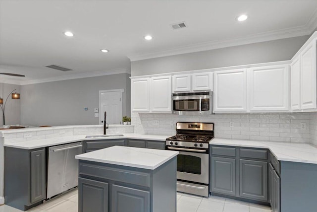 6301 Harrogate Dr, Austin, TX 78759 - kitchen with appliances with stainless steel finishes, a sink, gray cabinetry, a peninsula, and white cabinetry