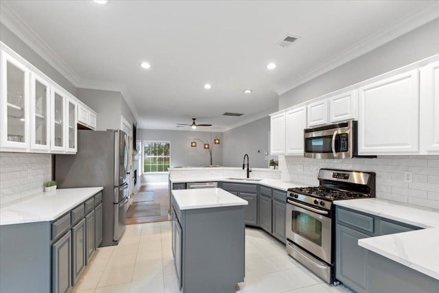 6301 Harrogate Dr, Austin, TX 78759 - kitchen featuring appliances with stainless steel finishes, a sink, gray cabinets, a peninsula, and white cabinetry