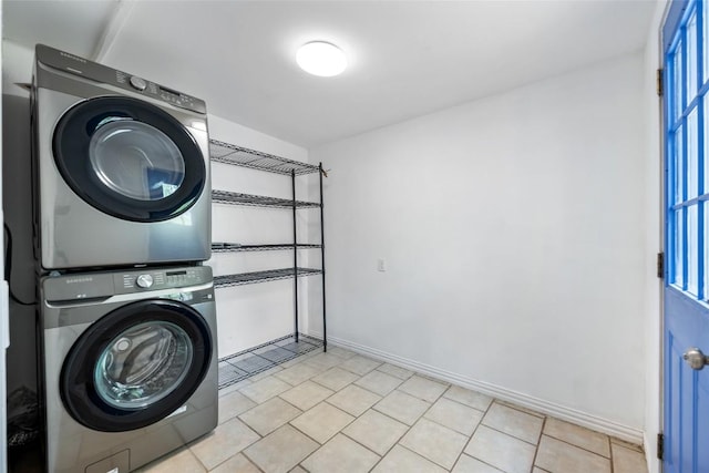 11708 Hornsby Dr, Austin, TX 78753 - laundry room featuring estacked washer and dryer and baseboards