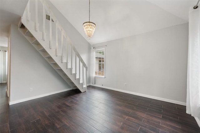 11708 Hornsby Dr, Austin, TX 78753 - unfurnished living room with stairway, dark wood-style floors, a chandelier, and baseboards