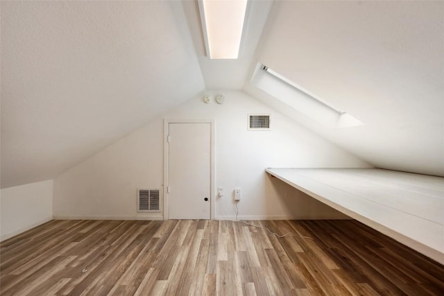 11708 Hornsby Dr, Austin, TX 78753 - bonus room featuring a skylight, vaulted ceiling, and wood finished floors