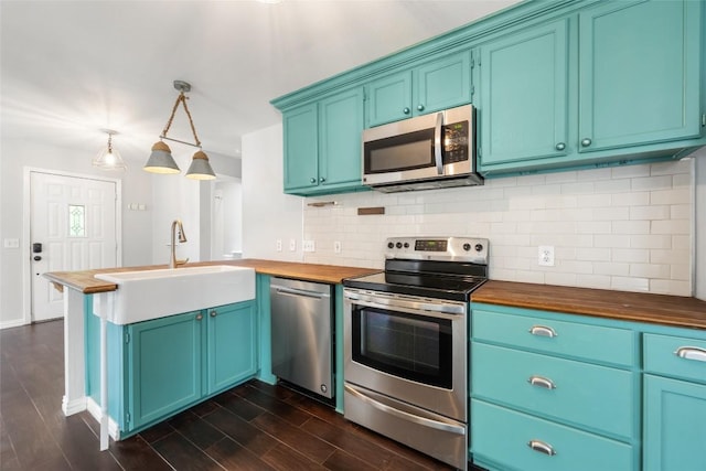 11708 Hornsby Dr, Austin, TX 78753 - kitchen featuring stainless steel appliances, wooden counters, a sink, a peninsula, and tasteful backsplash