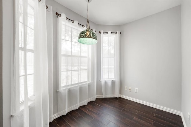 11708 Hornsby Dr, Austin, TX 78753 - unfurnished dining area featuring baseboards and dark wood-type flooring
