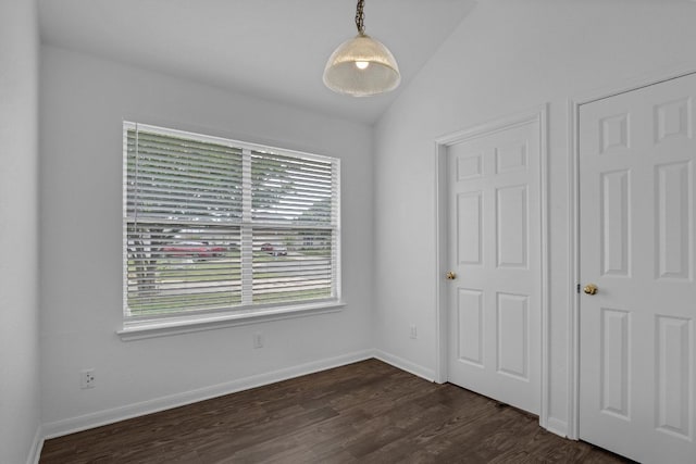 211 Warner Bnd, Hutto, TX 78634 - unfurnished bedroom with dark wood-style flooring, vaulted ceiling, and baseboards