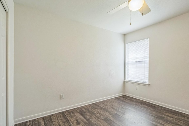 211 Warner Bnd, Hutto, TX 78634 - unfurnished room with dark wood-style floors, baseboards, and ceiling fan