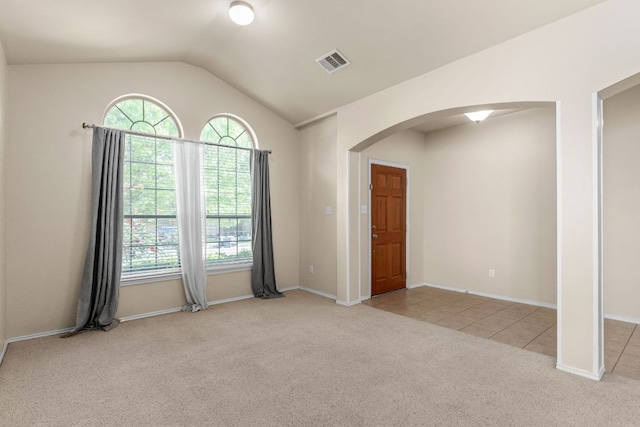 5405 English Oak Dr, Killeen, TX 76542 - carpeted empty room with baseboards, vaulted ceiling, tile patterned flooring, visible vents, and arched walkways