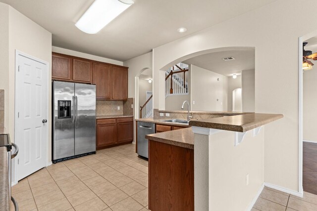 5405 English Oak Dr, Killeen, TX 76542 - kitchen with light tile patterned floors, arched walkways, visible vents, appliances with stainless steel finishes, and a sink