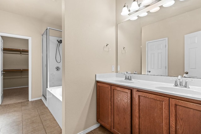 5405 English Oak Dr, Killeen, TX 76542 - bathroom with a sink, a walk in closet, double vanity, and tile patterned flooring