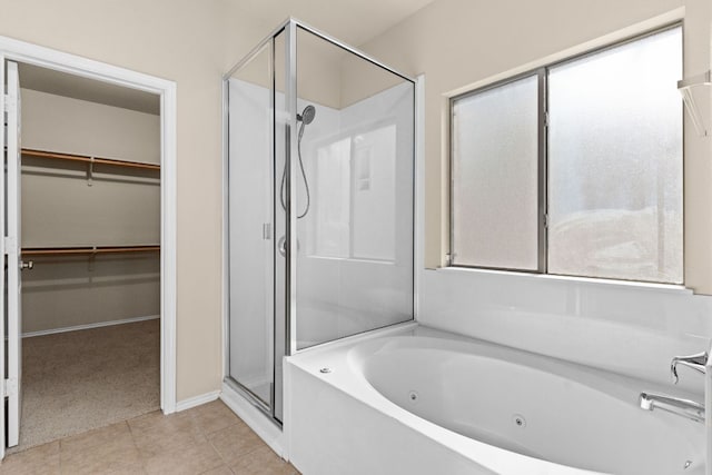 5405 English Oak Dr, Killeen, TX 76542 - bathroom featuring a walk in closet, a jetted tub, a shower stall, and tile patterned flooring