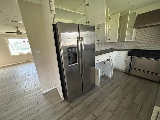 1008 W Pietzsch St, Bartlett, TX 76511 - kitchen with appliances with stainless steel finishes, range hood, white cabinets, and baseboards