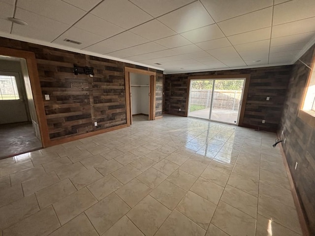 1008 W Pietzsch St, Bartlett, TX 76511 - unfurnished room featuring wooden walls and a drop ceiling