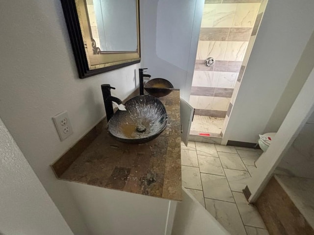 1008 W Pietzsch St, Bartlett, TX 76511 - full bath featuring marble look tiles, vanity, tiled shower, and baseboards