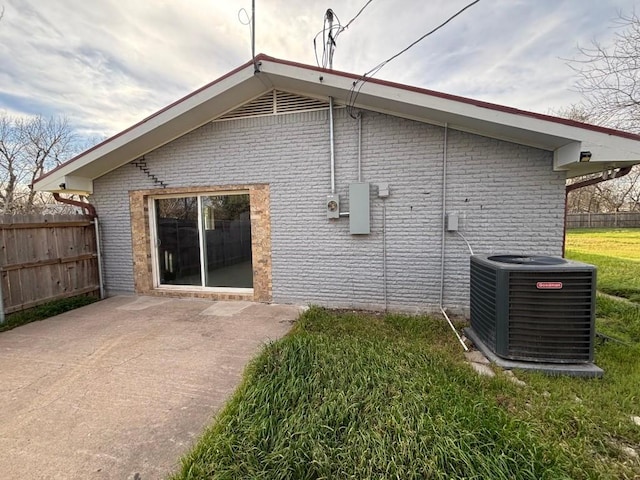 1008 W Pietzsch St, Bartlett, TX 76511 - view of side of property with cooling unit, brick siding, and a patio area