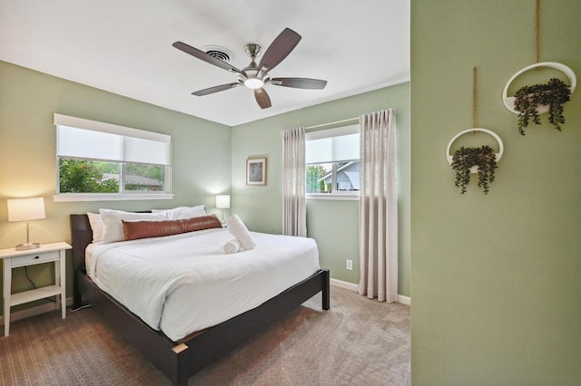 2301 Trafalgar Dr, Austin, TX 78723 - carpeted bedroom with multiple windows, baseboards, and a ceiling fan