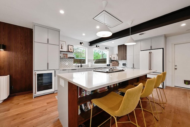 2301 Trafalgar Dr, Austin, TX 78723 - kitchen featuring beverage cooler, open shelves, light wood-type flooring, a center island, and backsplash