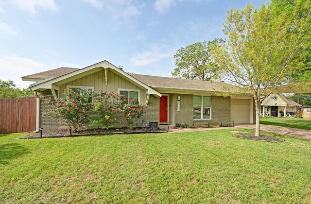 2301 Trafalgar Dr, Austin, TX 78723 - single story home featuring an attached garage, driveway, brick siding, and board and batten siding