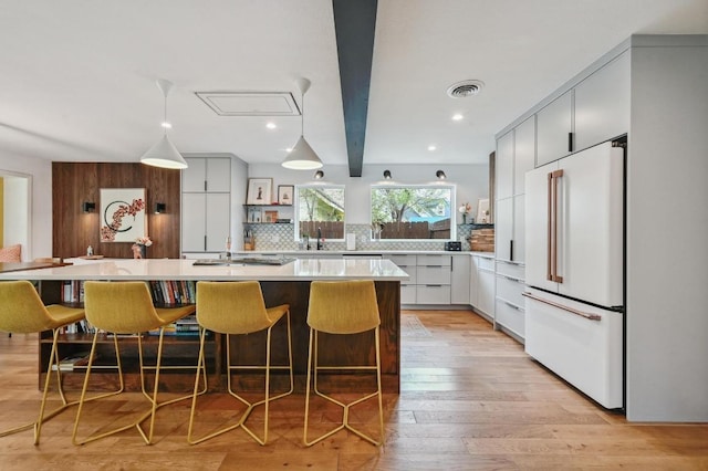 2301 Trafalgar Dr, Austin, TX 78723 - kitchen with freestanding refrigerator, modern cabinets, light countertops, decorative backsplash, and recessed lighting