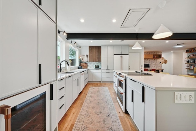 2301 Trafalgar Dr, Austin, TX 78723 - kitchen with high end appliances, modern cabinets, backsplash, light countertops, and light wood finished floors