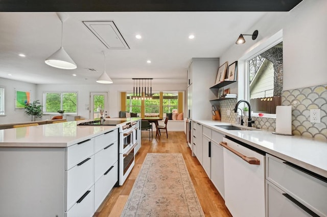 2301 Trafalgar Dr, Austin, TX 78723 - kitchen with white appliances, plenty of natural light, white cabinets, and recessed lighting