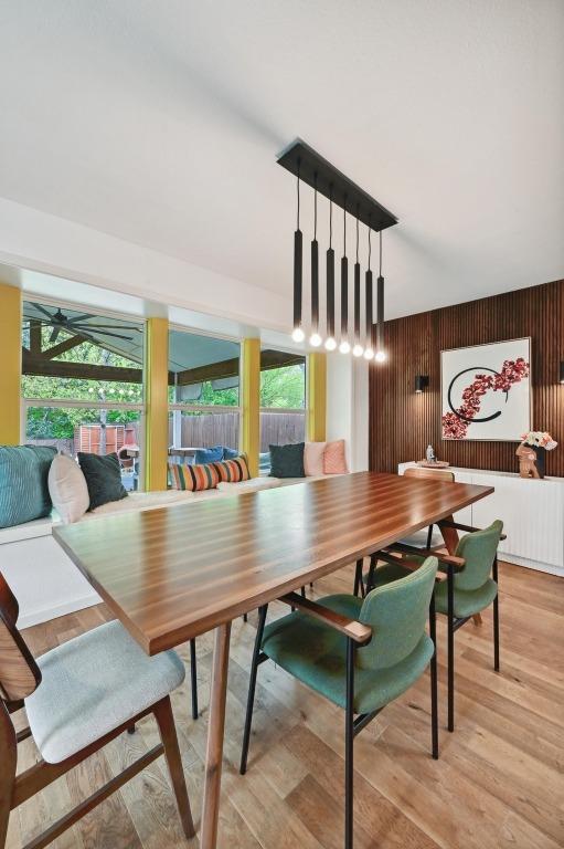 2301 Trafalgar Dr, Austin, TX 78723 - dining space with healthy amount of natural light, light wood-style flooring, and wooden walls