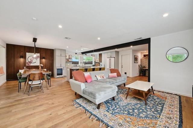 2301 Trafalgar Dr, Austin, TX 78723 - living area with wine cooler, recessed lighting, light wood-style floors, and wooden walls