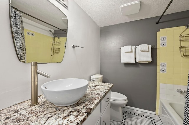 2425 Ashdale Dr Unit 78, Austin, TX 78757 - full bathroom featuring baseboards, toilet, a textured ceiling, vanity, and tile patterned floors